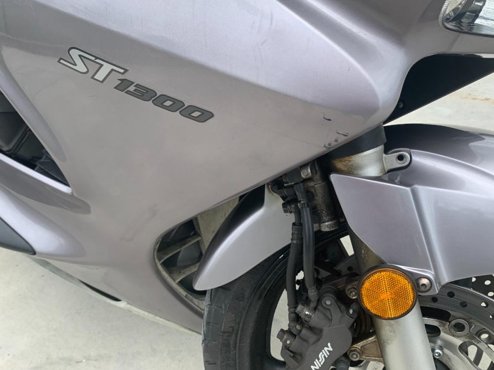 2003 Silver Honda ST1300 ST1300 (JH2SC51103M) with an 1261CC engine, 5 SPEED transmission, located at 17760 HWY 62, MORRIS, 74445, 35.609104, -95.877060 - 2003 HONDA ST1300 IS A 1261CC 5-SPEED TRANSMISSION WITH AN ELECTRIC START, POWER-ADJUSTABLE LIGHTS, POWER-ADJUSTABLE WINDSHIELD, NICE CLEAN TOURING SPORTS BIKE. ONLY 17,093 MILES, MARATHON TIRES, DOES HAVE REBUILT TITLE DUE TO A SMALL ACCIDENT. LIGHT SCRAPES AS SHOWN IN PICTURES. $3,900 CALL R - Photo #13