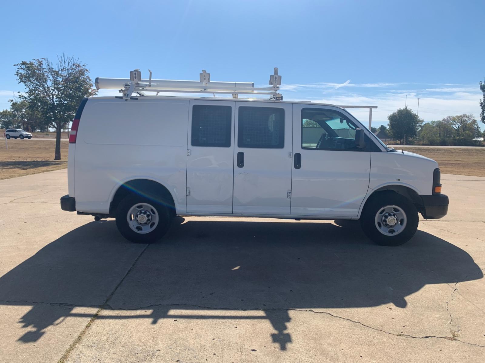 2013 White Chevrolet Express 2500 Cargo (1GCWGFCB9D1) with an 6.0L V8 OHV 16V FFV engine, 6-Speed Automatic transmission, located at 17760 Hwy 62, Morris, OK, 74445, (918) 733-4887, 35.609104, -95.877060 - 2013 CHEVROLET EXPRESS CARGO VAN 6.0L V8 RWD FEATURING POWER LOCKS, MANUAL WINDOWS, MANUAL MIRRORS, MANUAL SEATS, AM/FM STEREO, LEATHER SEATS, LEATHER-WRAPPED STEERING WHEEL, TACHOMETER, TRACTION CONTROL, LOCKING METAL CONSOLE, STEEL SHELVES, SPLIT SWING-OUT RIGHT DOORS, RUBBER MATS, LOAD-BEARING E - Photo #3