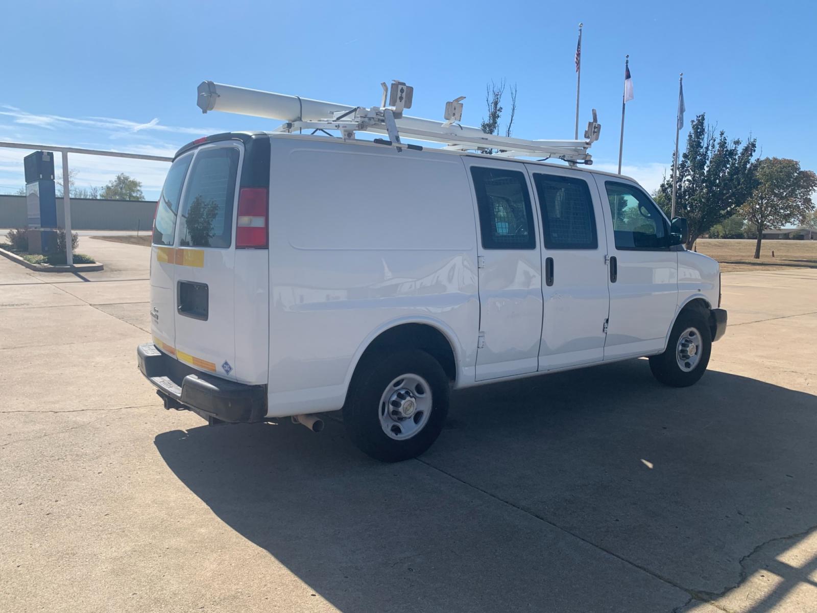 2013 White Chevrolet Express 2500 Cargo (1GCWGFCB9D1) with an 6.0L V8 OHV 16V FFV engine, 6-Speed Automatic transmission, located at 17760 Hwy 62, Morris, OK, 74445, (918) 733-4887, 35.609104, -95.877060 - 2013 CHEVROLET EXPRESS CARGO VAN 6.0L V8 RWD FEATURING POWER LOCKS, MANUAL WINDOWS, MANUAL MIRRORS, MANUAL SEATS, AM/FM STEREO, LEATHER SEATS, LEATHER-WRAPPED STEERING WHEEL, TACHOMETER, TRACTION CONTROL, LOCKING METAL CONSOLE, STEEL SHELVES, SPLIT SWING-OUT RIGHT DOORS, RUBBER MATS, LOAD-BEARING E - Photo #4