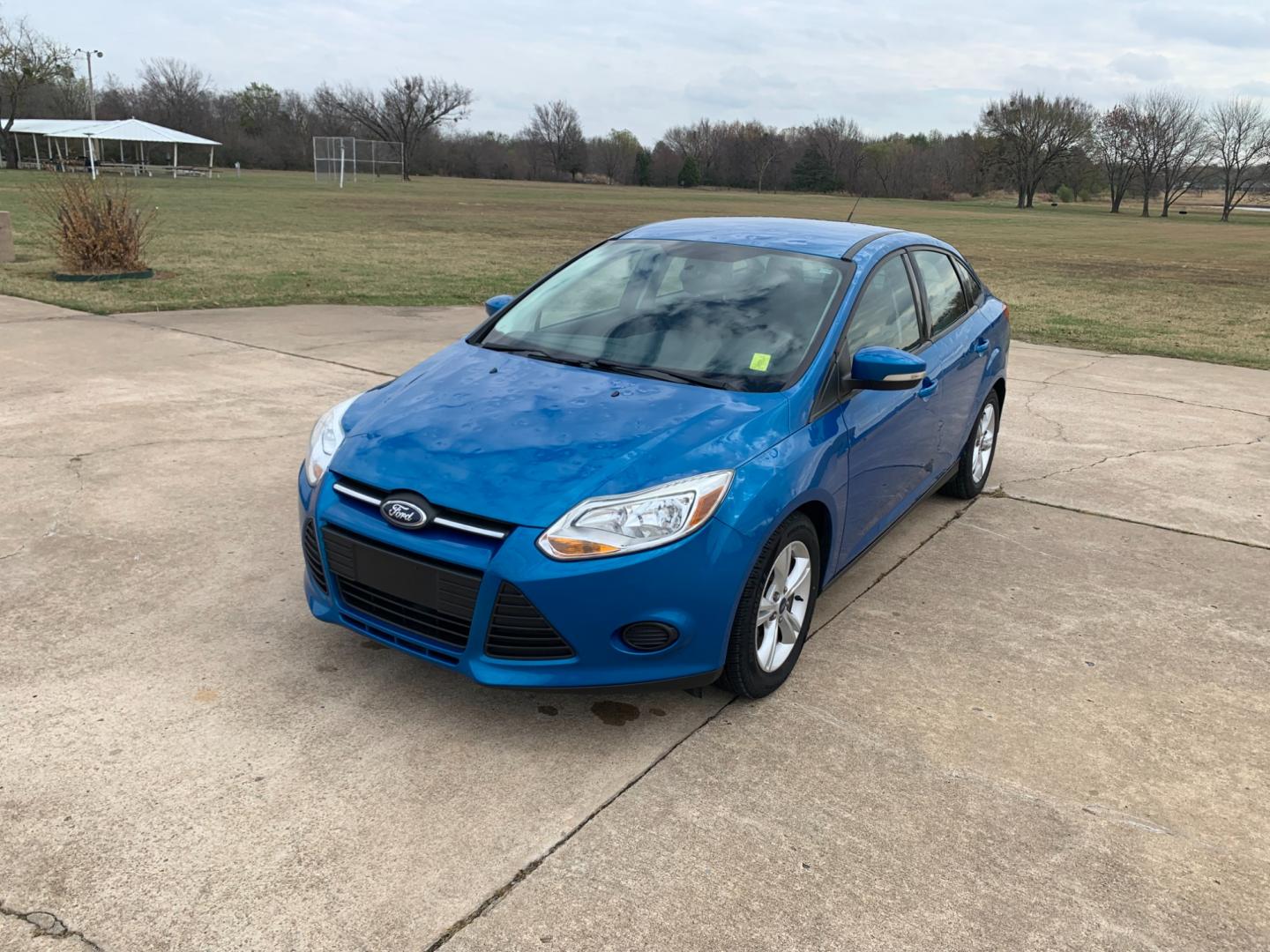2014 BLUE Ford Focus SE Sedan (1FADP3F25EL) with an 2.0L L4 DOHC 16V engine, AUTOMATIC transmission, located at 17760 Hwy 62, Morris, OK, 74445, (918) 733-4887, 35.609104, -95.877060 - Photo#0