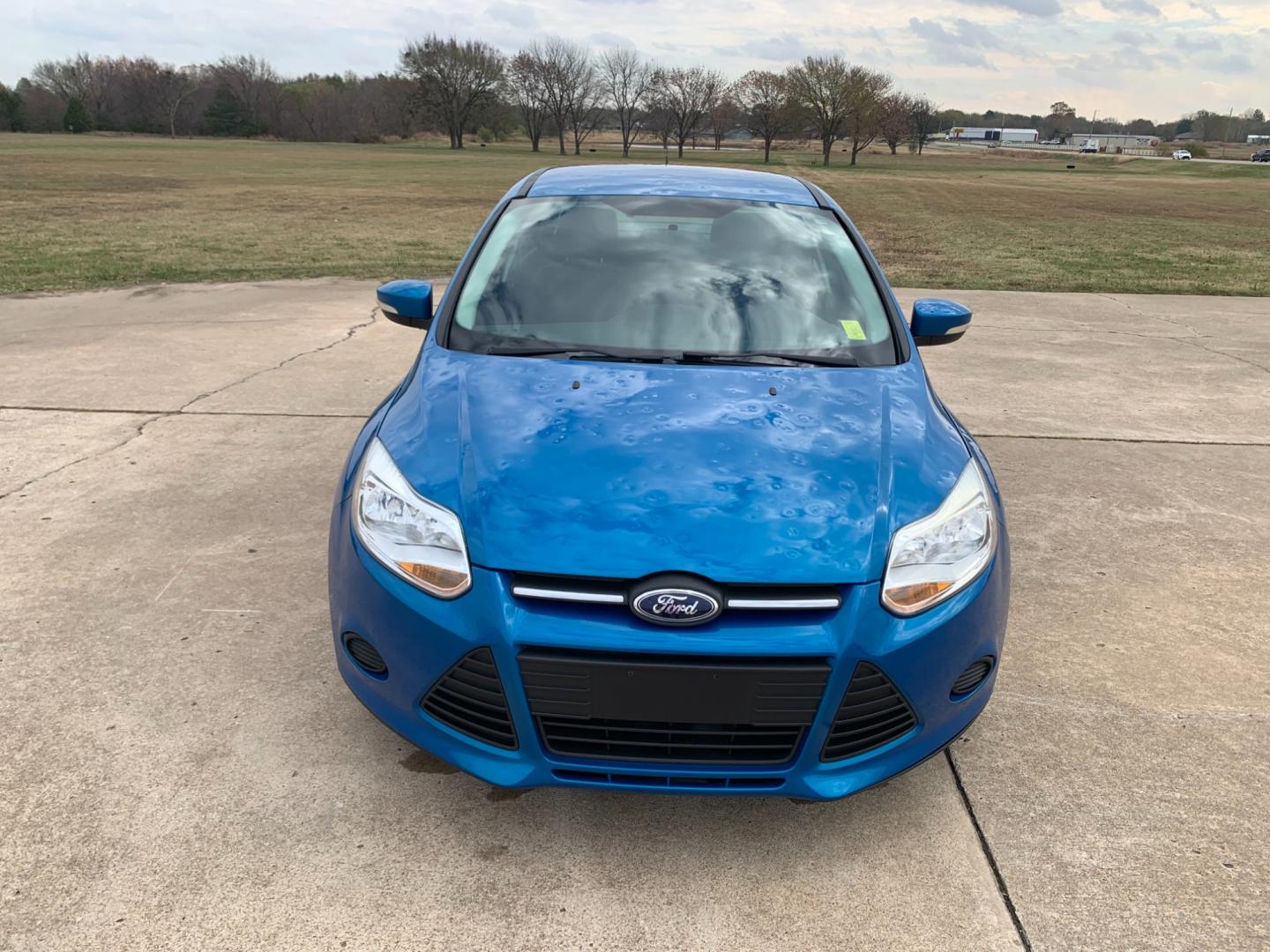 2014 BLUE Ford Focus SE Sedan (1FADP3F25EL) with an 2.0L L4 DOHC 16V engine, AUTOMATIC transmission, located at 17760 Hwy 62, Morris, OK, 74445, (918) 733-4887, 35.609104, -95.877060 - Photo#1