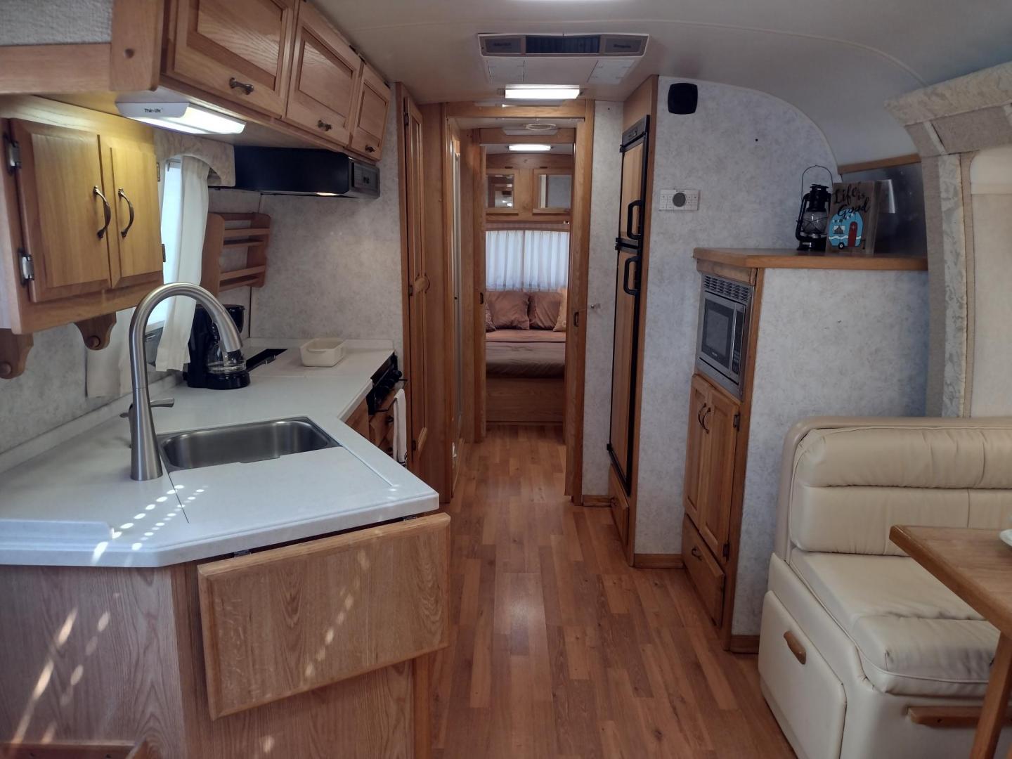2003 Silver /TAN AIRSTREAM M30 LIMITED M30 LIMITED (1STJBBP213J) , located at 17760 Hwy 62, Morris, OK, 74445, 35.609104, -95.877060 - GRAB IT WHILE YOU CAN!!! 2003 AIRSTREAM CLASSIC LIMITED M30 WITH SLIDE OUT OVERALL 31FT. IN THE LIVING/KITCHEN AREA IS LEATHER SOFA THAT FOLDS DOWN FOR ADDITIONAL SLEEPING, STORAGE DRAWER UNDER SOFA, HAS A SIDE TABLE, OVERHEAD STORAGE CABINETS, LEATHER BOOTH STYLE DINETTE THAT FOLDS DOWN FOR ADDITIO - Photo#11