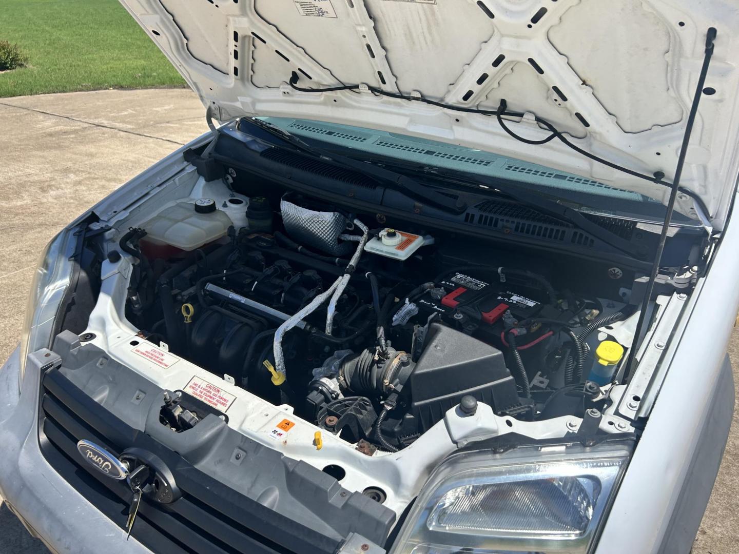 2012 White /Gray Ford Transit Connect XL with Rear Door Glass (NM0LS7AN8CT) with an 2.0L L4 DOHC 16V engine, 4-Speed Automatic transmission, located at 17760 Hwy 62, Morris, OK, 74445, (918) 733-4887, 35.609104, -95.877060 - 2012 FORD TRANSIT CONNECT HAS THE 2.0L ENGINE. THIS IS A DEDICATED CNG THAT ONLY RUNS ON COMPRESSED NATURAL GAS AND IS NOT EQUIPPED TO RUN ON GASOLINE. IT FEATURES MANUAL WINDOWS, MANUAL LOCKS, MANUAL SEATS, CLOTH INTERIOR, BACKUP CAMERA, AM/FM RADIO, STORAGE DRAWERS IN CARGO AREA, 205/65R15 TIRES - Photo#18