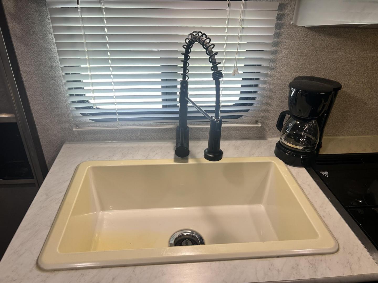 2020 WHITE Forest River OZARK TRAIL 2700THX 2700THX (4X4TZKC27LY) , located at 17760 Hwy 62, Morris, OK, 74445, 35.609104, -95.877060 - CAMPING SEASON IS HERE CHECK OUT THIS 2020 FOREST RIVER OZARK TRAIL 2700THX TOY HAULER 31FT OVERALL WITH 15FT POWER AWNING. IN THE FRONT IS THE QUEEN SIZE BED WITH STORAGE UNDER THE BED, OVERHEAD CABINET, AND WARDROBE CLOSET. IN THE LIVING AND KITCHEN AREA IS A U-SHAPED DINETTE THAT FOLDS DOWN FOR A - Photo#18