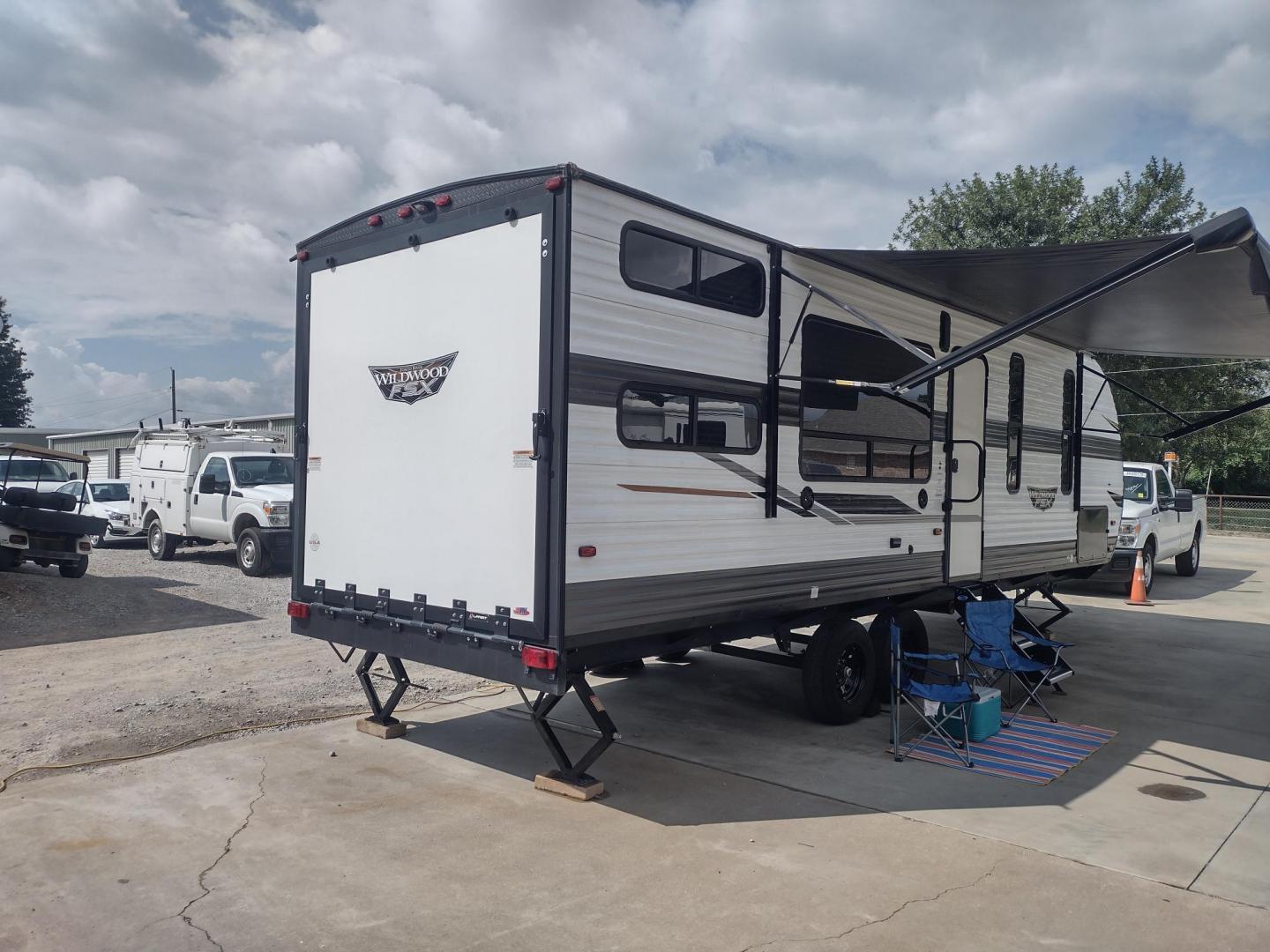 2022 WHITE /Gray Forest River WILDWOOD 270RTK 270RTK (4X4TWDC28NY) , located at 17760 Hwy 62, Morris, OK, 74445, 35.609104, -95.877060 - CHECK OUT THIS 2022 FOREST RIVER WILDWOOD 270RTK 32FT OVERALL WITH 18FT POWER AWNING. IN THE LIVING AND KITCHEN AREA IS A BOOTH STYLE DINETTE THAT FOLD DOWN FOR ADDITIONAL SLEEPING OR FOLDS UP FOR CARGO SPACE, ELECTRIC FIRE PLACE WITH CABINET SPACE, 3 BURNER STOVE (NO OVEN), FARM STYLE SINK, MICROWA - Photo#2