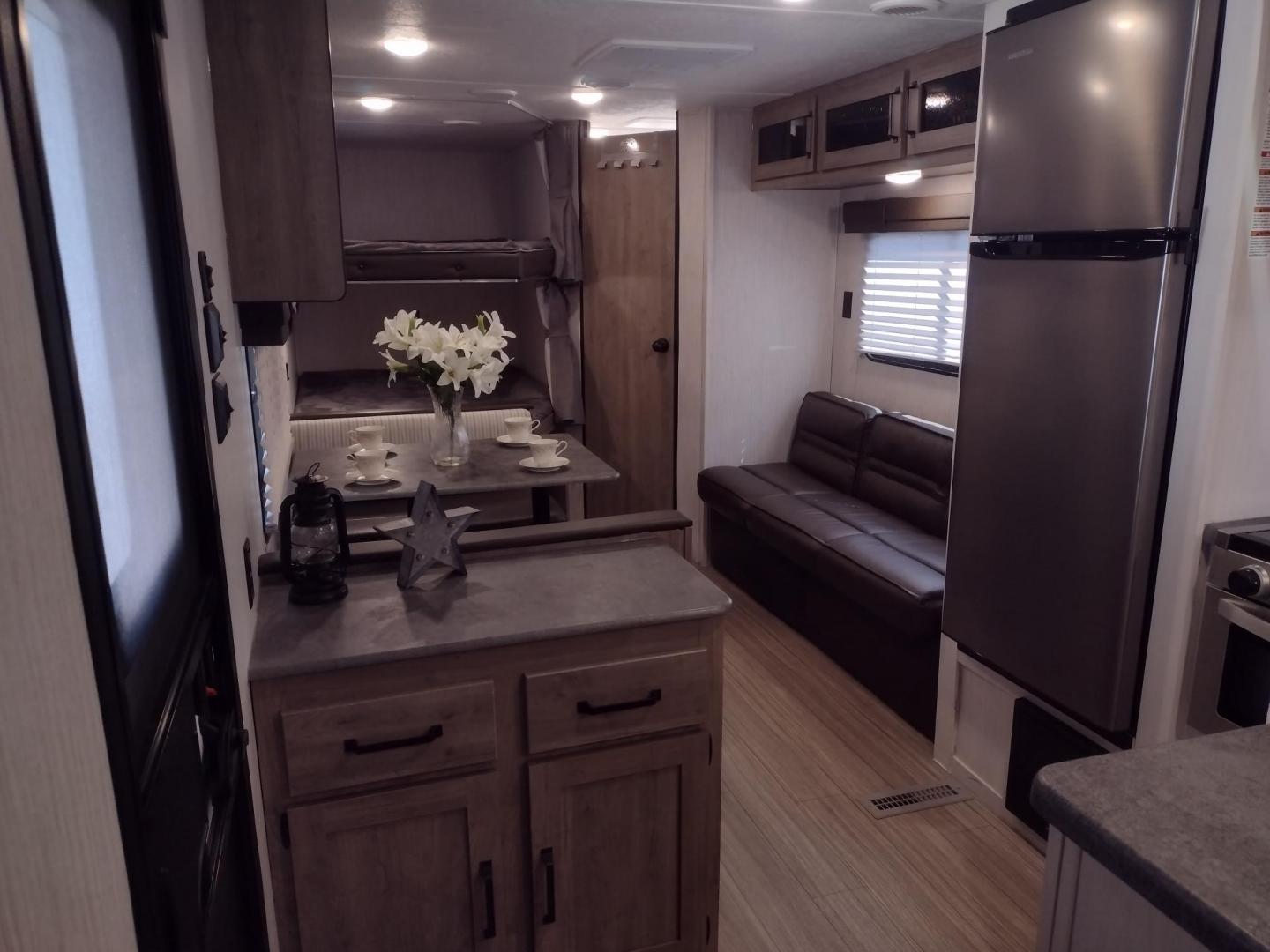 2022 WHITE /Gray Forest River PUMA XLE LITE 23BHC 23BHC (5ZT2PUMB9N4) , located at 17760 Hwy 62, Morris, OK, 74445, 35.609104, -95.877060 - READY FOR AN ADVENTURE CHECK OUT THIS 2022 FOREST RIVER PUMA XLE LITE 23BHC 30FT OVERALL WITH 19FT POWER AWNING. IN THE FRONT IS THE BEDROOM WITH A QUEEN SIZE BED AND STORAGE UNDER THE BED, OVERHEAD SHELF, AND 2 WARDROBE CLOSETS. IN THE LIVING AND KITCHEN AREA IS STAINLESS STEEL FARM STYLE SINK, 3 B - Photo#8