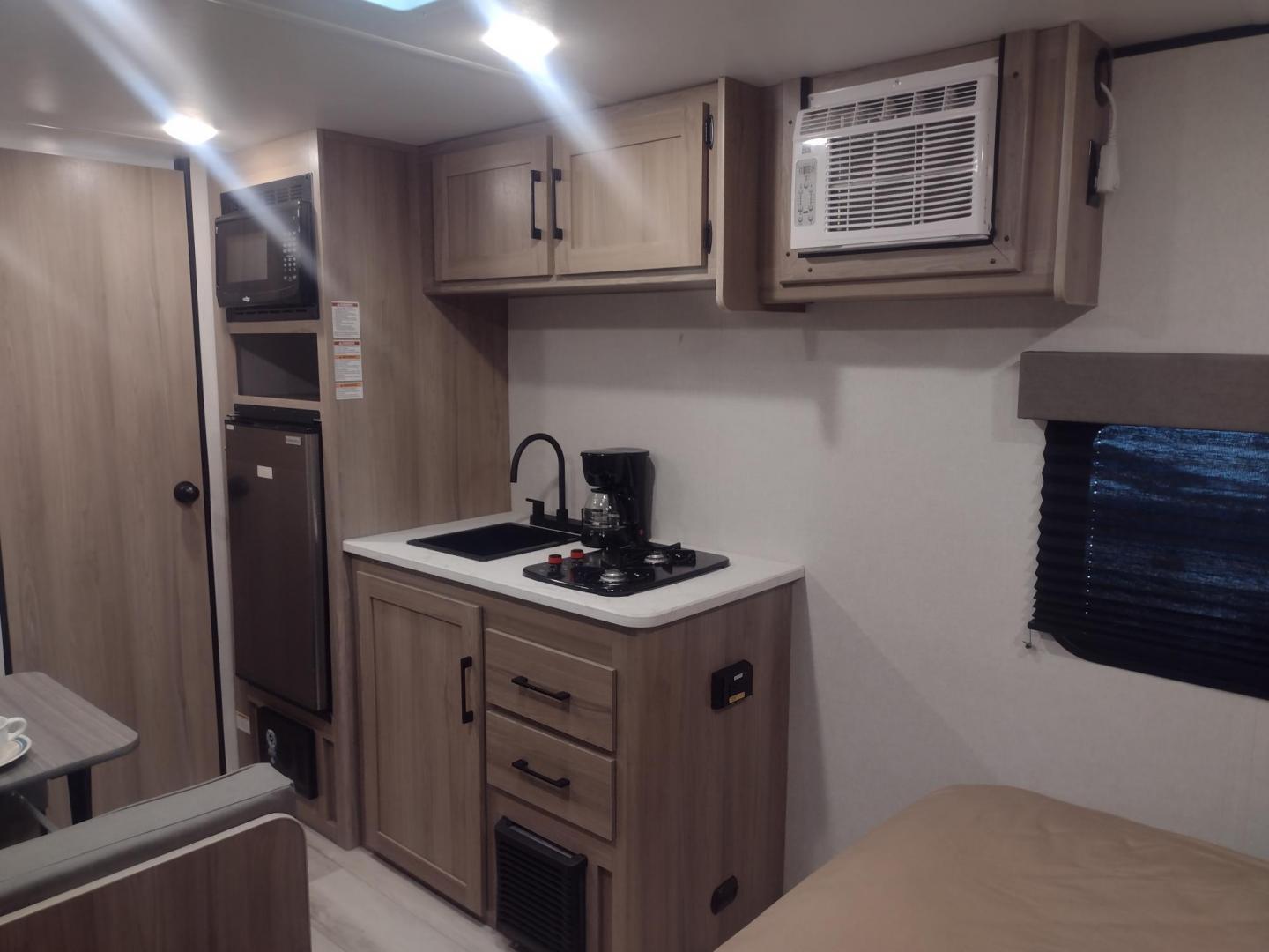 2025 White /TAN Keystone COLEMAN 17R 17R (4YDTCMG19SM) , located at 17760 Hwy 62, Morris, OK, 74445, 35.609104, -95.877060 - GRAB IT WHILE YOU CAN CHECK OUT THIS 2025 KEYSTONE COLEMAN 17R 21FT OVERALL WITH A 8FT POWER AWNING. IN THE FRONT IS A FULL SIZE BED WITH STORAGE UNDER THE BED, OVERHEAD SHELF, WARDROBE CLOSET, AND AC UNIT. IN THE LIVING AND KITCHEN AREA IS A 2 BURNER STOVE (NO OVEN), SINGLE SINK, OVERHEAD CABINETS, - Photo#8