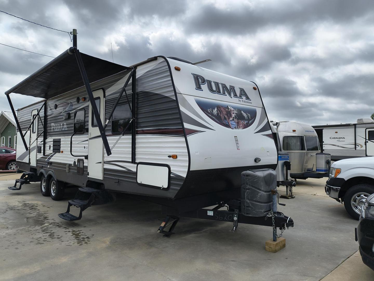 2015 White /BROWN Forest River PUMA 31BHSS 31BHSS (4X4TPUG23FP) , located at 17760 Hwy 62, Morris, OK, 74445, 35.609104, -95.877060 - CAMPING SEASON IS RIGHT AROUND THE CORNER SO CHECK OUT THIS 2015 FOREST RIVER PUMA 31BHSS 34.5FT OVERALL WITH 15FT POWER AWNING. IN THE FRONT IS THE MASTER BEDROOM WITH A QUEEN SIZE BED, STORAGE UNDER THE BED, TWO WARDROBE CLOSETS, AND OVERHEAD CABINETS. IN THE LIVING AND KITCHEN AREA THERE IS A ENT - Photo#0