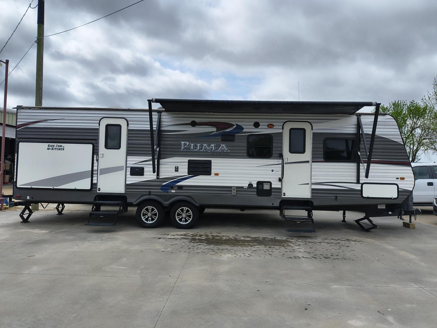 2015 White /BROWN Forest River PUMA 31BHSS 31BHSS (4X4TPUG23FP) , located at 17760 Hwy 62, Morris, OK, 74445, 35.609104, -95.877060 - CAMPING SEASON IS RIGHT AROUND THE CORNER SO CHECK OUT THIS 2015 FOREST RIVER PUMA 31BHSS 34.5FT OVERALL WITH 15FT POWER AWNING. IN THE FRONT IS THE MASTER BEDROOM WITH A QUEEN SIZE BED, STORAGE UNDER THE BED, TWO WARDROBE CLOSETS, AND OVERHEAD CABINETS. IN THE LIVING AND KITCHEN AREA THERE IS A ENT - Photo#1