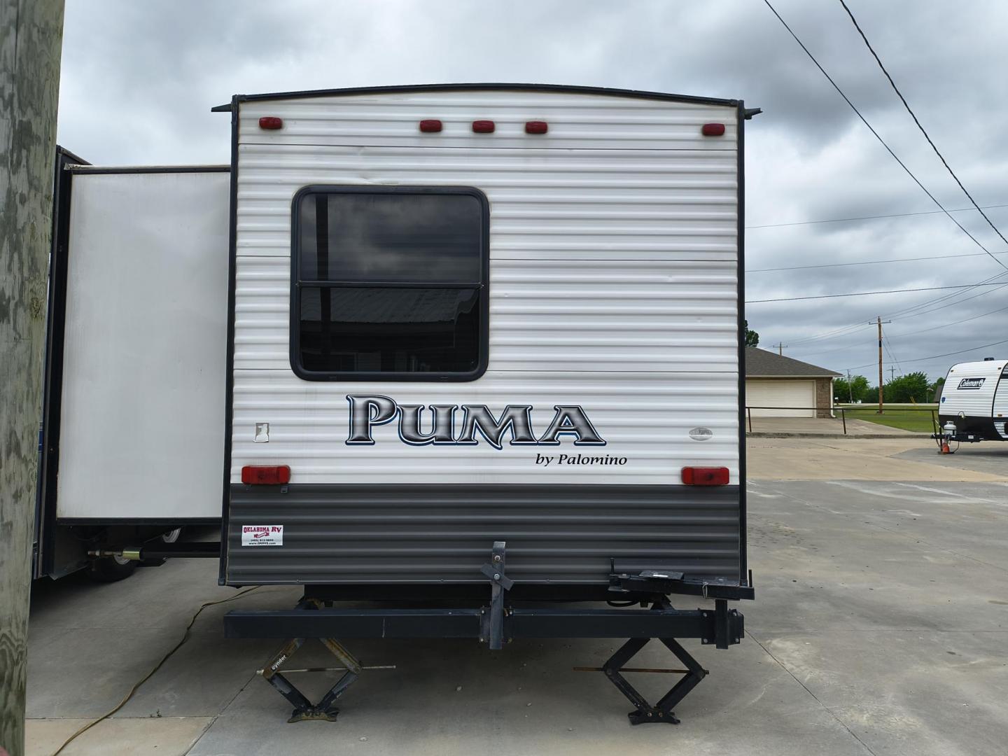 2015 White /BROWN Forest River PUMA 31BHSS 31BHSS (4X4TPUG23FP) , located at 17760 Hwy 62, Morris, OK, 74445, 35.609104, -95.877060 - CAMPING SEASON IS RIGHT AROUND THE CORNER SO CHECK OUT THIS 2015 FOREST RIVER PUMA 31BHSS 34.5FT OVERALL WITH 15FT POWER AWNING. IN THE FRONT IS THE MASTER BEDROOM WITH A QUEEN SIZE BED, STORAGE UNDER THE BED, TWO WARDROBE CLOSETS, AND OVERHEAD CABINETS. IN THE LIVING AND KITCHEN AREA THERE IS A ENT - Photo#3