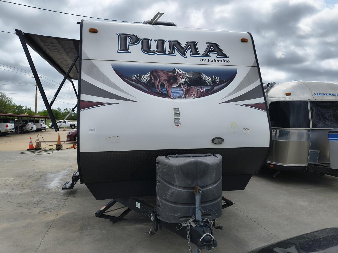 2015 White /BROWN Forest River PUMA 31BHSS 31BHSS (4X4TPUG23FP) , located at 17760 Hwy 62, Morris, OK, 74445, 35.609104, -95.877060 - CAMPING SEASON IS RIGHT AROUND THE CORNER SO CHECK OUT THIS 2015 FOREST RIVER PUMA 31BHSS 34.5FT OVERALL WITH 15FT POWER AWNING. IN THE FRONT IS THE MASTER BEDROOM WITH A QUEEN SIZE BED, STORAGE UNDER THE BED, TWO WARDROBE CLOSETS, AND OVERHEAD CABINETS. IN THE LIVING AND KITCHEN AREA THERE IS A ENT - Photo#6