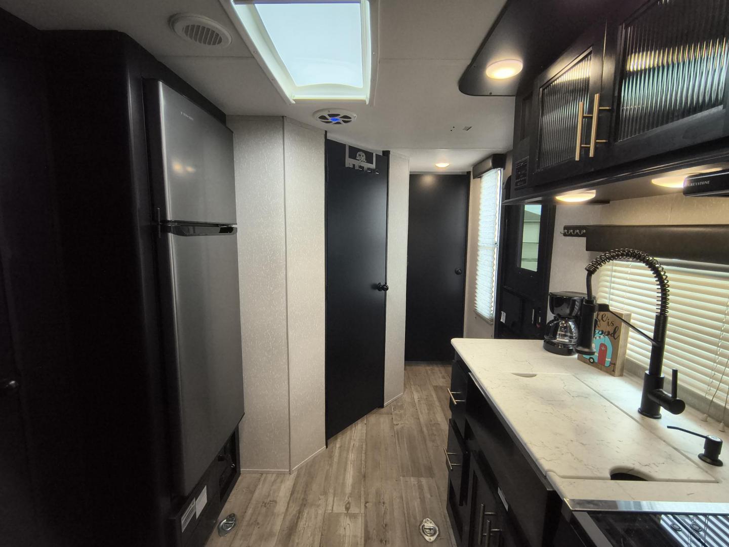 2022 Grey /Black Forest River 22RR - (4X4TCKX20NK) , located at 17760 Hwy 62, Morris, OK, 74445, 35.609104, -95.877060 - SPRING HAS SPRUNG AND SUMMER IS ON THE WAY!!! BIKERS WILL ENJOY THIS TOY HAULER. IT IS READY TO HIT THE ROAD AND ENJOY YOUR SUMMER. THIS CAMPER IS 30FT OVERALL HAS A QUEEN SIZED MASTER BED WITH A CLOSET WARDROBE ON EACH SIDE AND TV MOUNT. THE BATHROOM HAS A STANDUP ENCLOSED SHOWER WITH SINK AND VANI - Photo#11