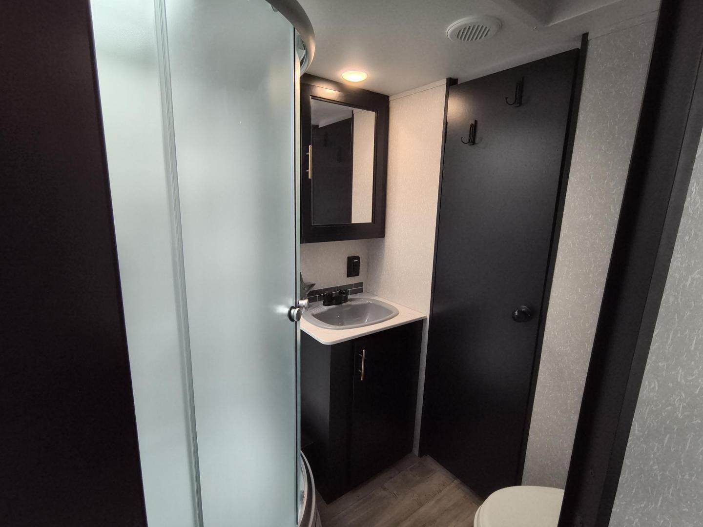 2022 Grey /Black Forest River 22RR - (4X4TCKX20NK) , located at 17760 Hwy 62, Morris, OK, 74445, 35.609104, -95.877060 - SPRING HAS SPRUNG AND SUMMER IS ON THE WAY!!! BIKERS WILL ENJOY THIS TOY HAULER. IT IS READY TO HIT THE ROAD AND ENJOY YOUR SUMMER. THIS CAMPER IS 30FT OVERALL HAS A QUEEN SIZED MASTER BED WITH A CLOSET WARDROBE ON EACH SIDE AND TV MOUNT. THE BATHROOM HAS A STANDUP ENCLOSED SHOWER WITH SINK AND VANI - Photo#31