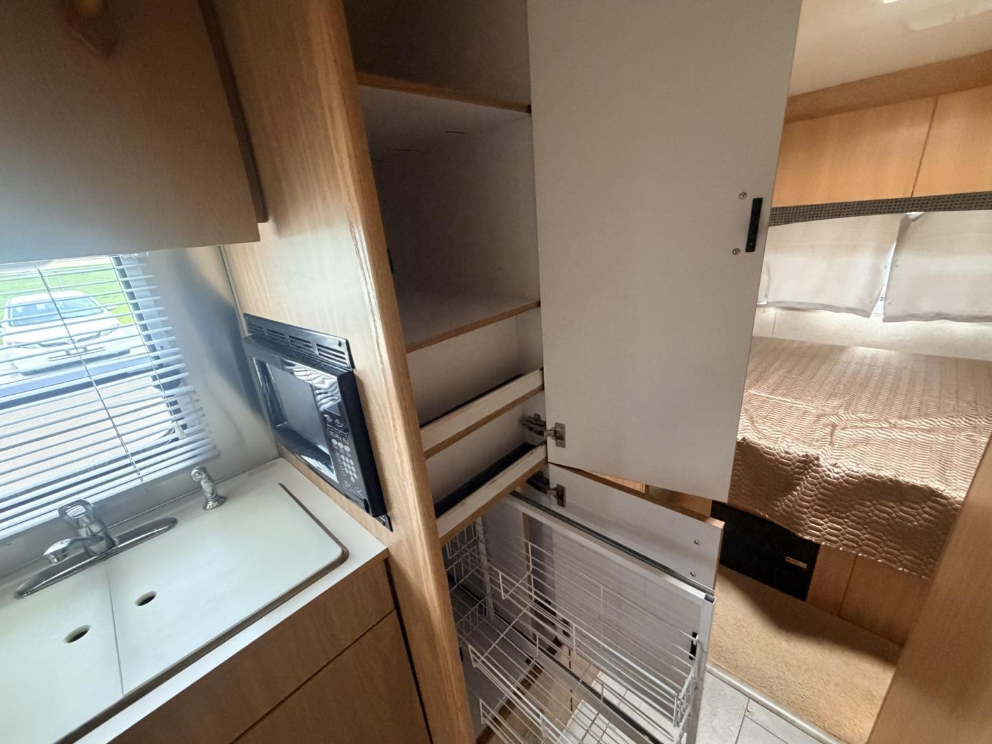 2005 Silver /TAN AIRSTREAM SAFARI - (1STGPYJ295J) , located at 17760 Hwy 62, Morris, OK, 74445, 35.609104, -95.877060 - 2005 AIRSTREAM SAFARI 25.5FT OVERALL WITH 16FT MANUAL AWNING. IN THE LIVING AND KITCHEN AREA IS A SOFA THAT FOLDS DOWN FOR ADDITIONAL SLEEPING, STORAGE UNDER THE SOFA, OVERHEAD CABINETS, FOLD OUT DINETTE TABLE, FOLD OUT END TABLE, 3 BURNING STOVE WITH OVEN, DOUBLE STAINLESS STEEL SINK, OVERHEAD CAB- Photo#30